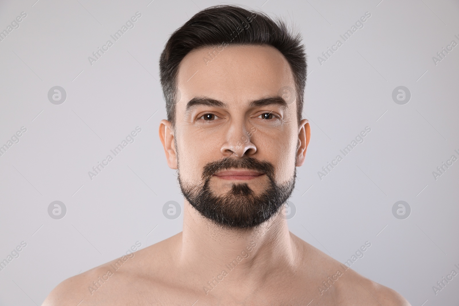 Portrait of handsome man on grey background, closeup Photo of Portrait of handsome man on grey background, closeup