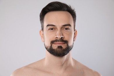 Photo of Portrait of handsome man on grey background, closeup