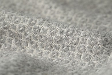 Photo of Texture of light grey wool fabric as background, closeup