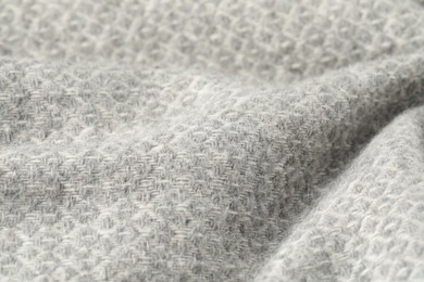 Photo of Texture of light grey wool fabric as background, closeup
