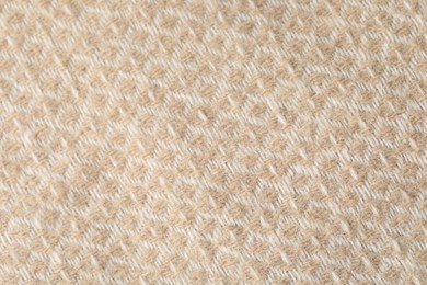 Photo of Texture of beige wool fabric as background, top view
