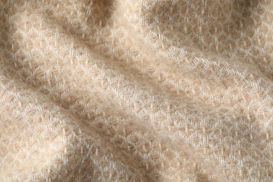 Photo of Texture of beige wool fabric as background, top view