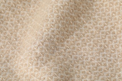 Photo of Texture of beige wool fabric as background, closeup