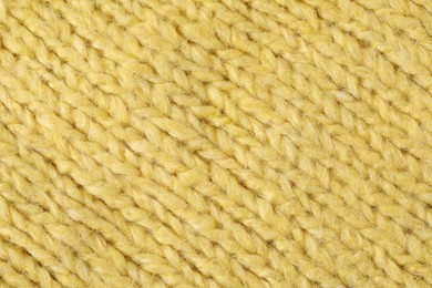 Photo of Texture of yellow wool fabric as background, top view