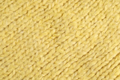 Photo of Texture of yellow wool fabric as background, top view