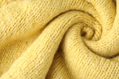 Photo of Texture of yellow wool fabric as background, top view