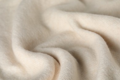 Photo of Texture of beige wool fabric as background, closeup