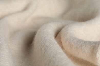 Photo of Texture of beige wool fabric as background, closeup