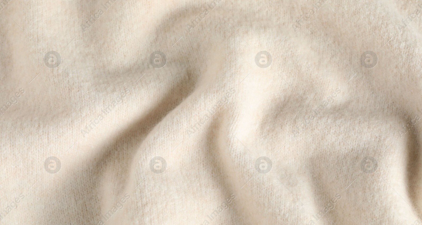 Photo of Texture of beige wool fabric as background, top view