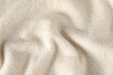 Photo of Texture of beige wool fabric as background, top view