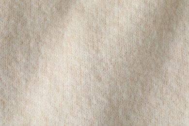 Photo of Texture of beige wool fabric as background, top view