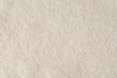 Photo of Texture of beige wool fabric as background, top view