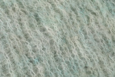 Photo of Texture of turquoise wool fabric as background, top view
