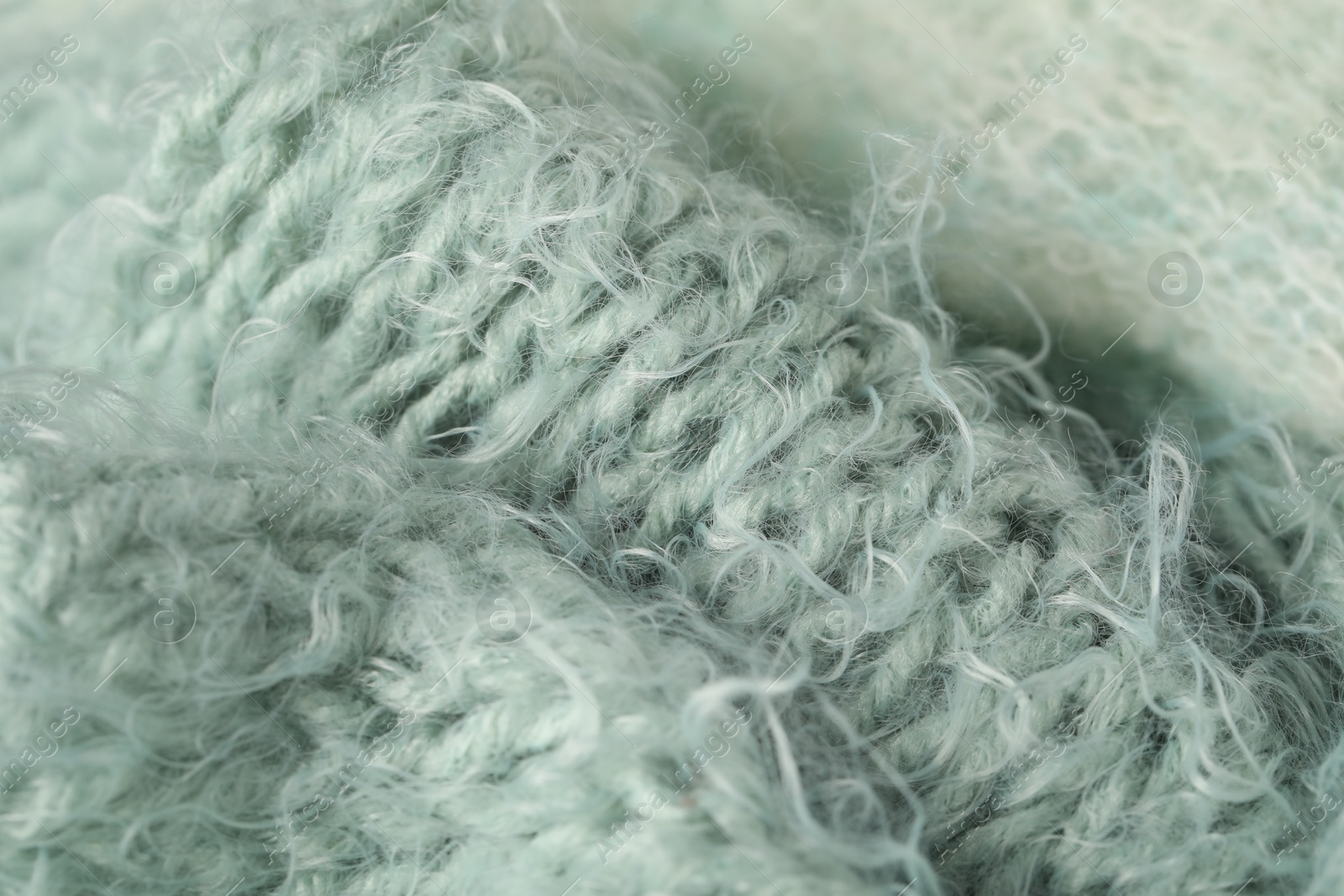 Photo of Texture of turquoise wool fabric as background, closeup