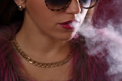 Photo of Woman in sunglasses smoking cigarette, closeup. Bad habit