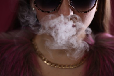 Photo of Woman in sunglasses smoking cigarette, closeup. Bad habit