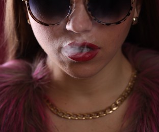 Photo of Woman in sunglasses smoking cigarette, closeup. Bad habit