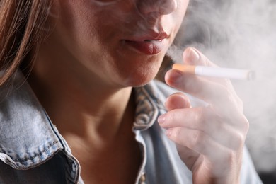 Photo of Woman in shirt smoking cigarette, closeup. Bad habit