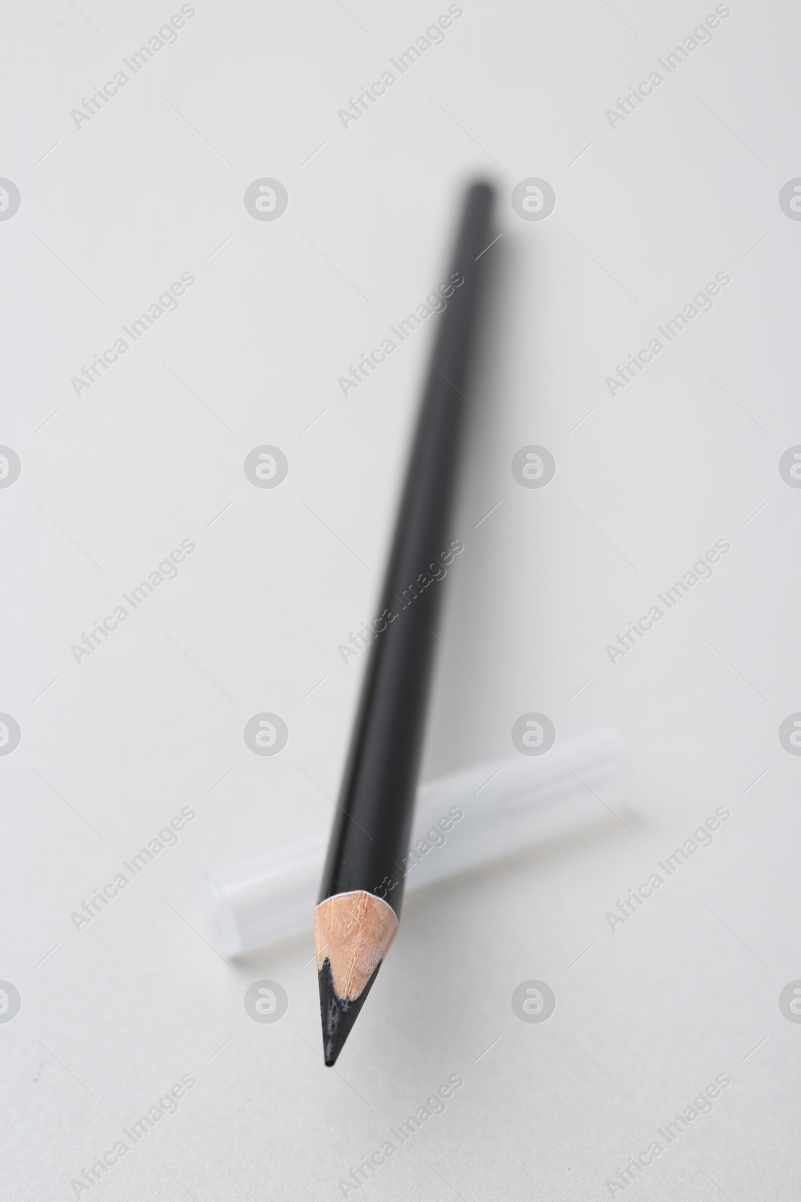 Black eyebrow pencil on light background, closeup Photo of Black eyebrow pencil on light background, closeup