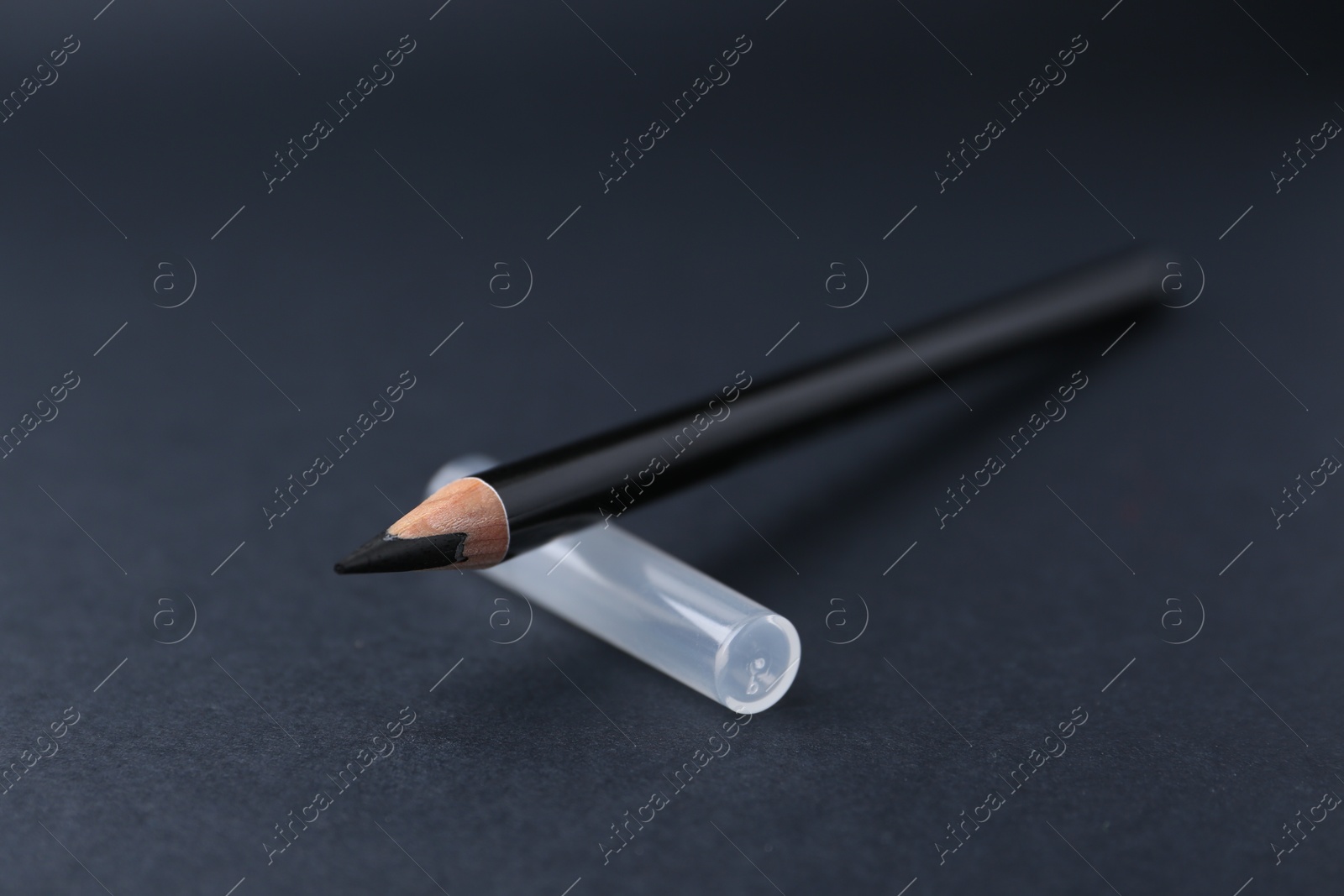 Black eyebrow pencil on dark background, closeup Photo of Black eyebrow pencil on dark background, closeup