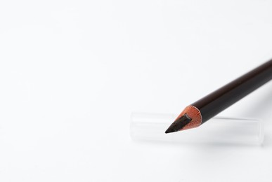Photo of Brown eyebrow pencil on white background, closeup. Space for text