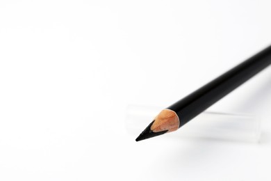 Photo of Black eyebrow pencil on white background, closeup. Space for text
