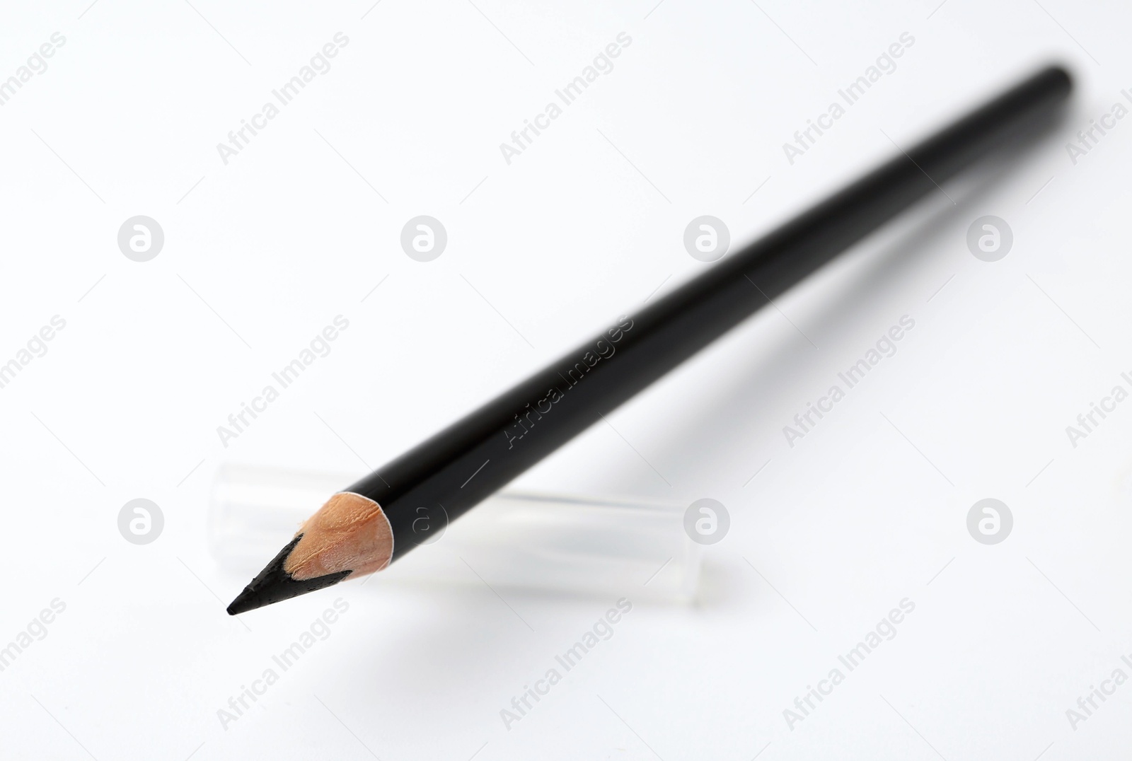 Black eyebrow pencil on white background, closeup. Space for text Photo of Black eyebrow pencil on white background, closeup. Space for text