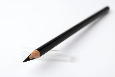 Photo of Black eyebrow pencil on white background, closeup. Space for text