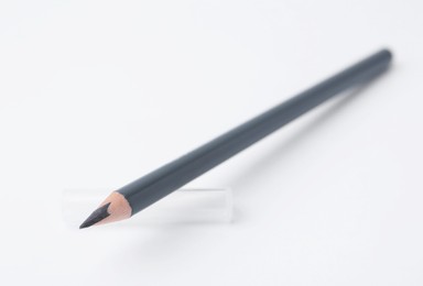 Photo of Grey eyebrow pencil on white background, closeup