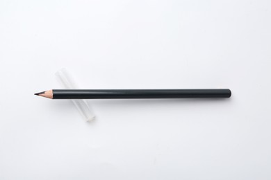 Photo of Black eyebrow pencil on white background, top view