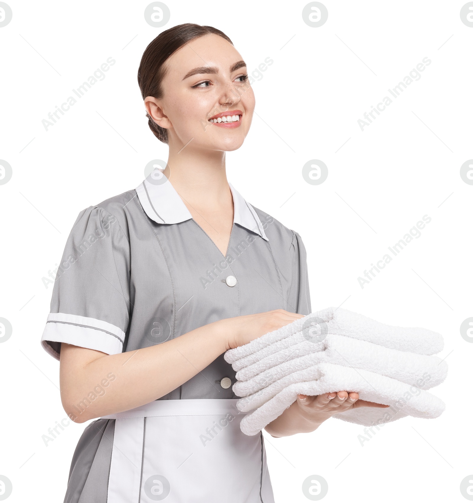Chambermaid with stack of clean towels on white background Photo of Chambermaid with stack of clean towels on white background
