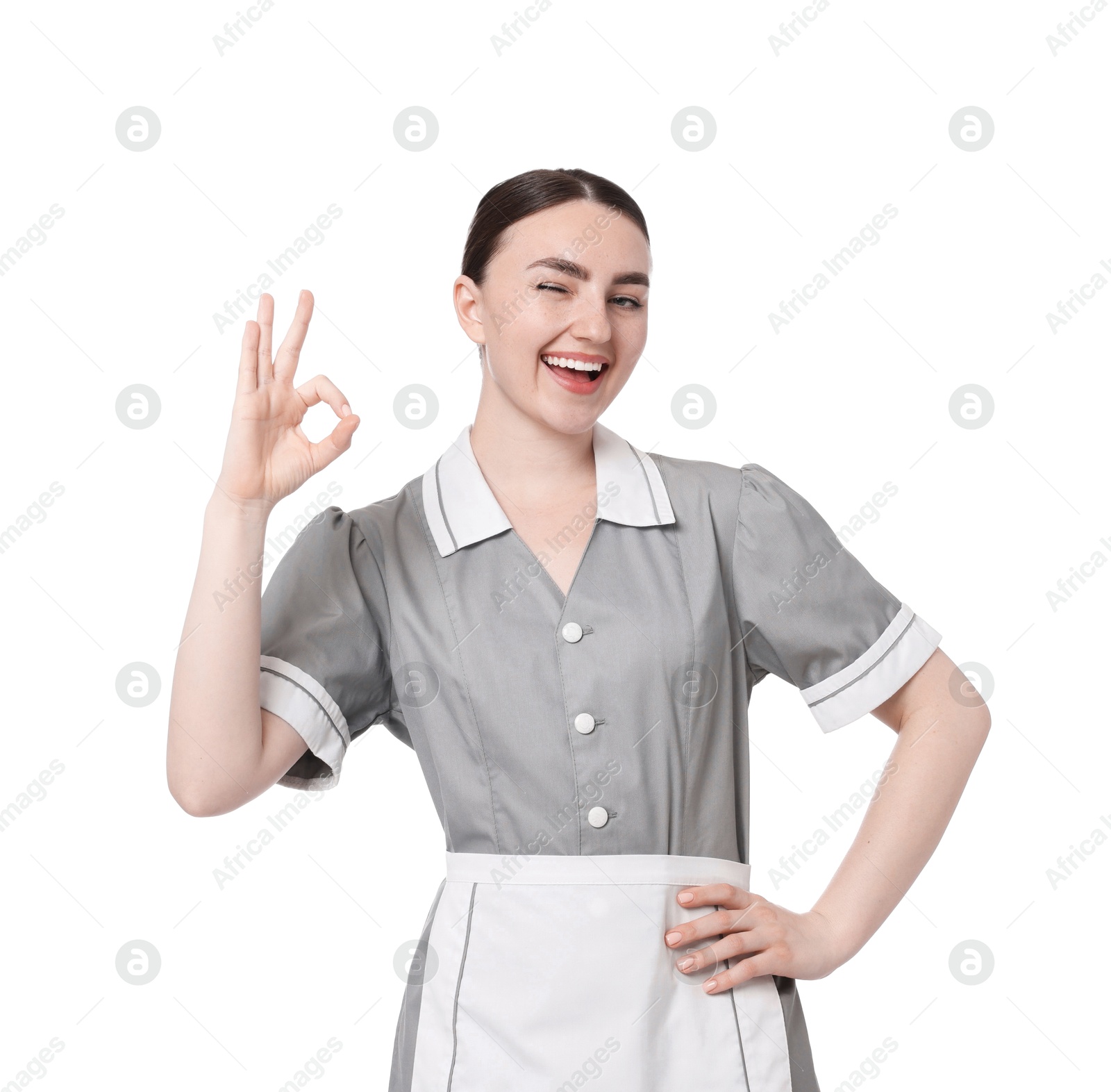 Happy chambermaid showing ok gesture on white background Photo of Happy chambermaid showing ok gesture on white background