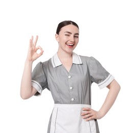 Photo of Happy chambermaid showing ok gesture on white background