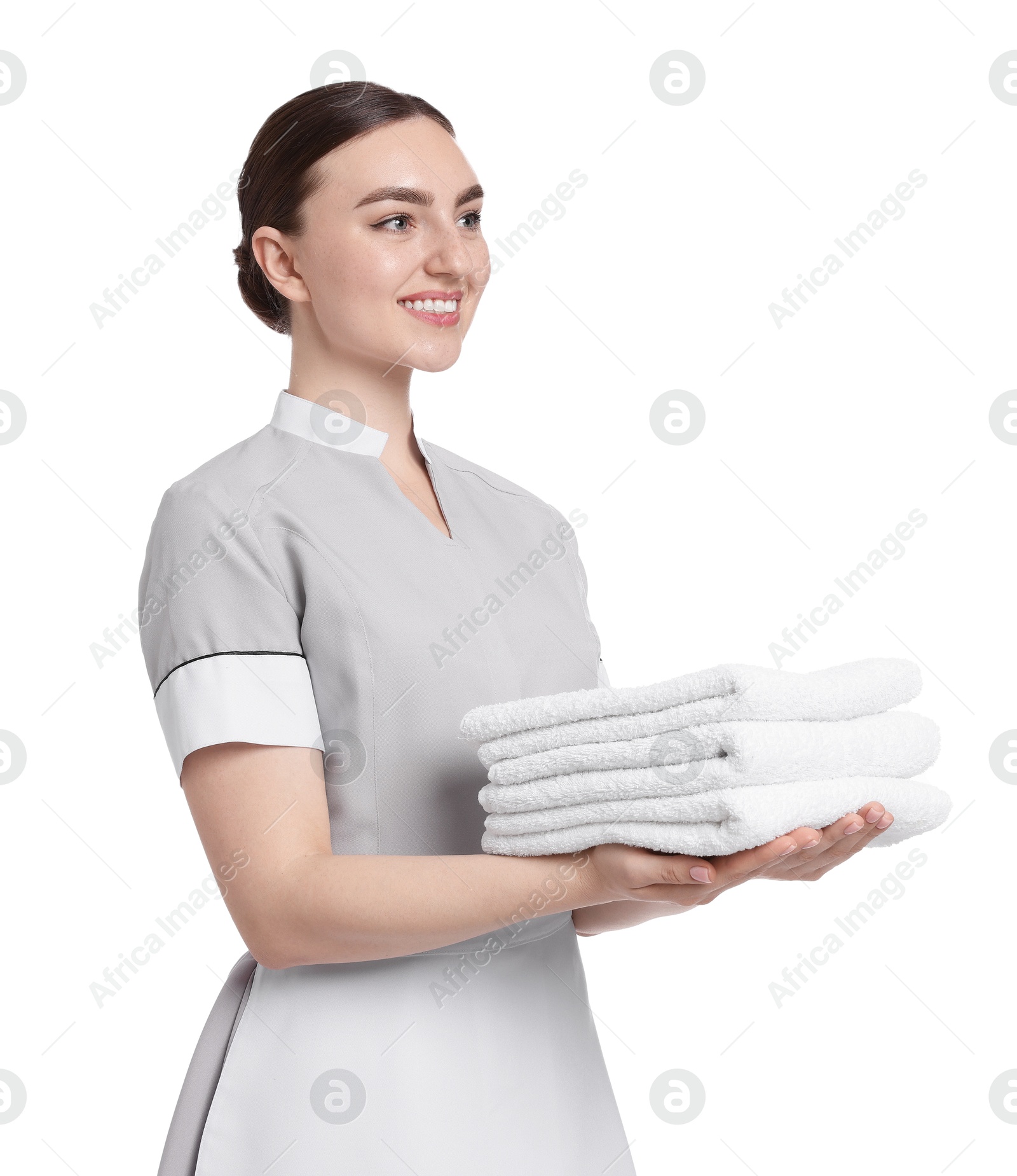 Chambermaid with stack of clean towels on white background Photo of Chambermaid with stack of clean towels on white background