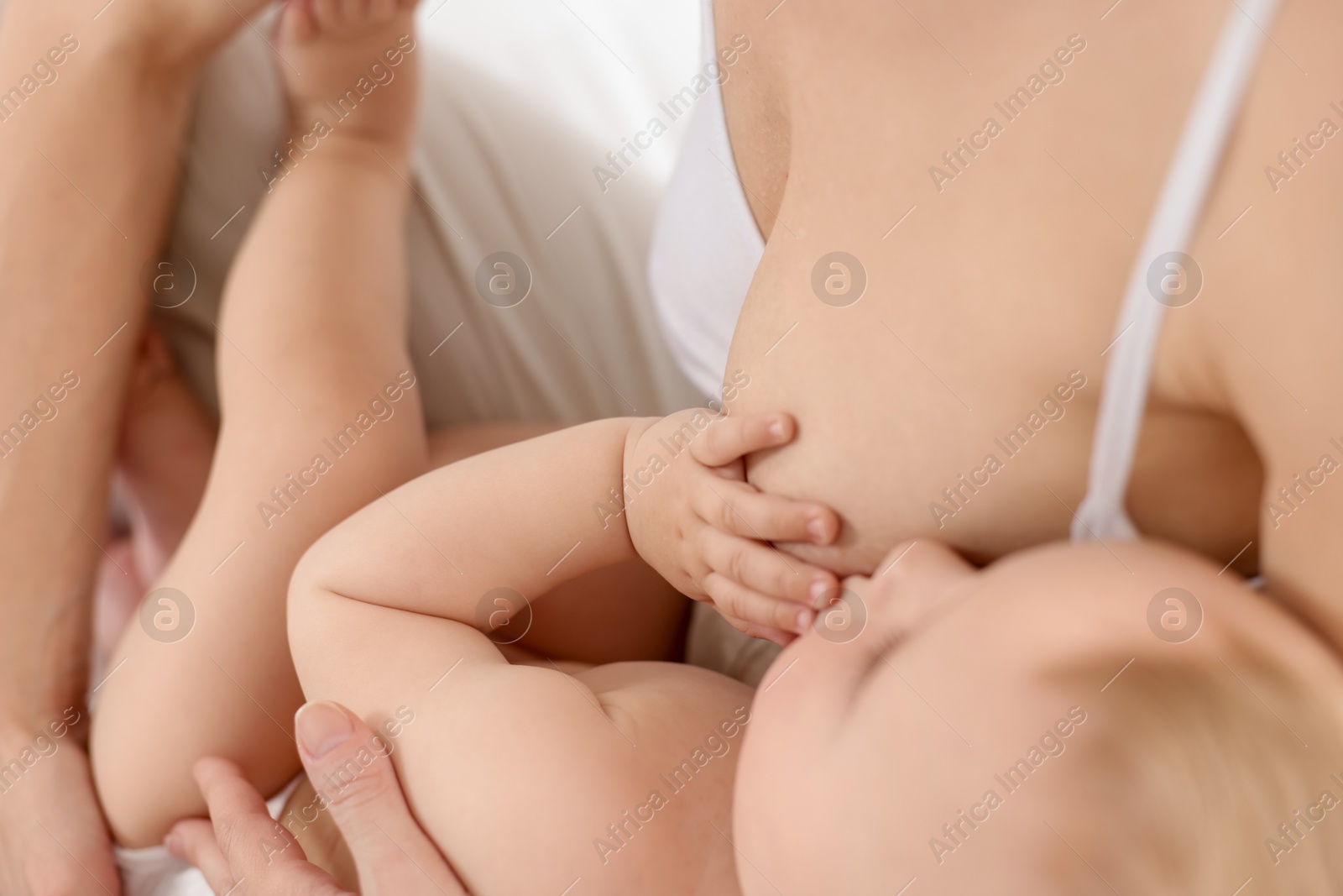 Mother breastfeeding her little baby indoors, closeup Photo of Mother breastfeeding her little baby indoors, closeup
