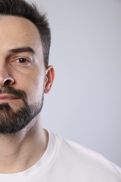 Photo of Handsome man on grey background, closeup view