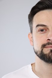 Photo of Handsome man on grey background, closeup view