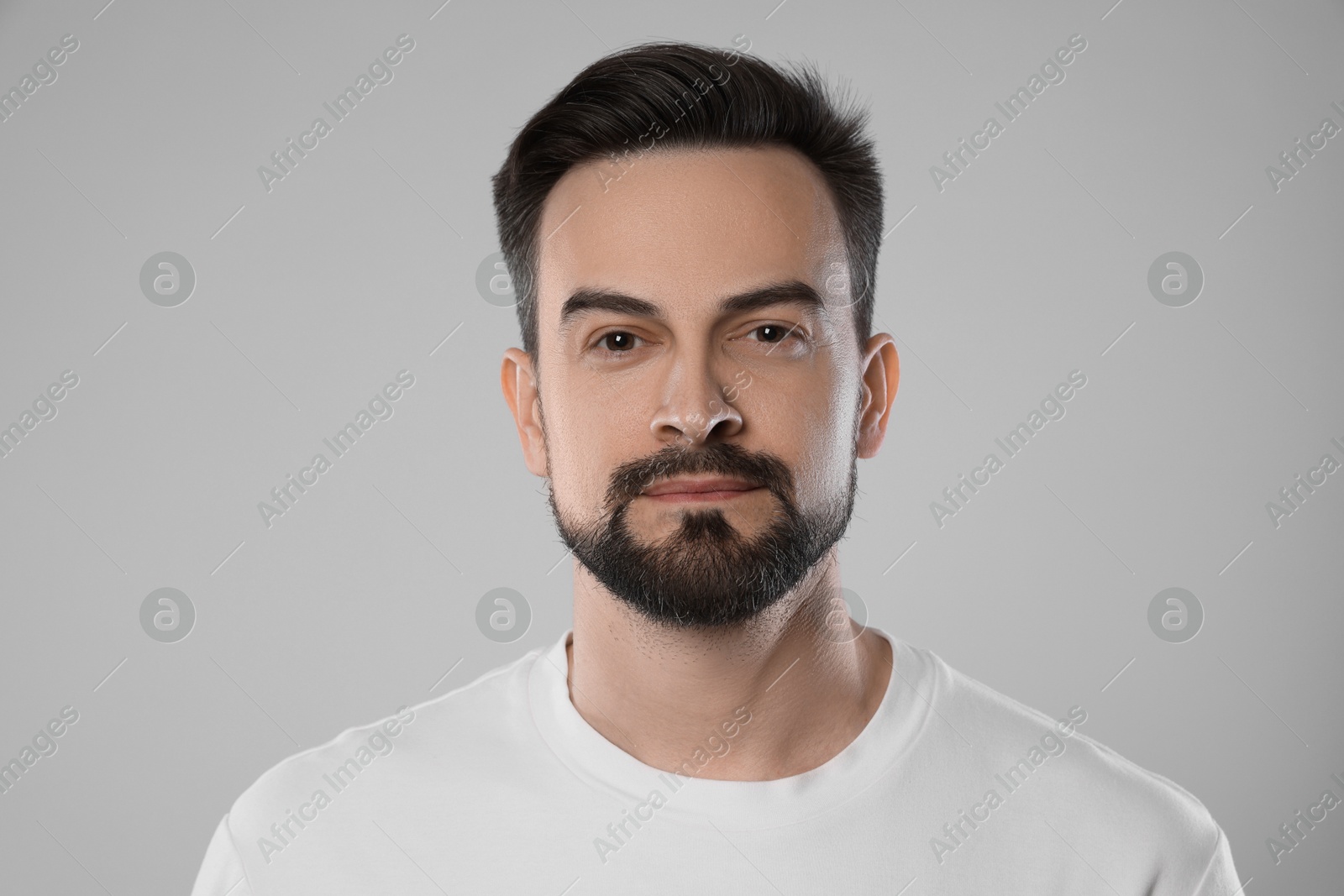 Portrait of handsome man on grey background, closeup Photo of Portrait of handsome man on grey background, closeup