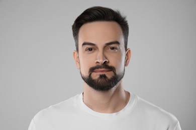 Photo of Portrait of handsome man on grey background, closeup