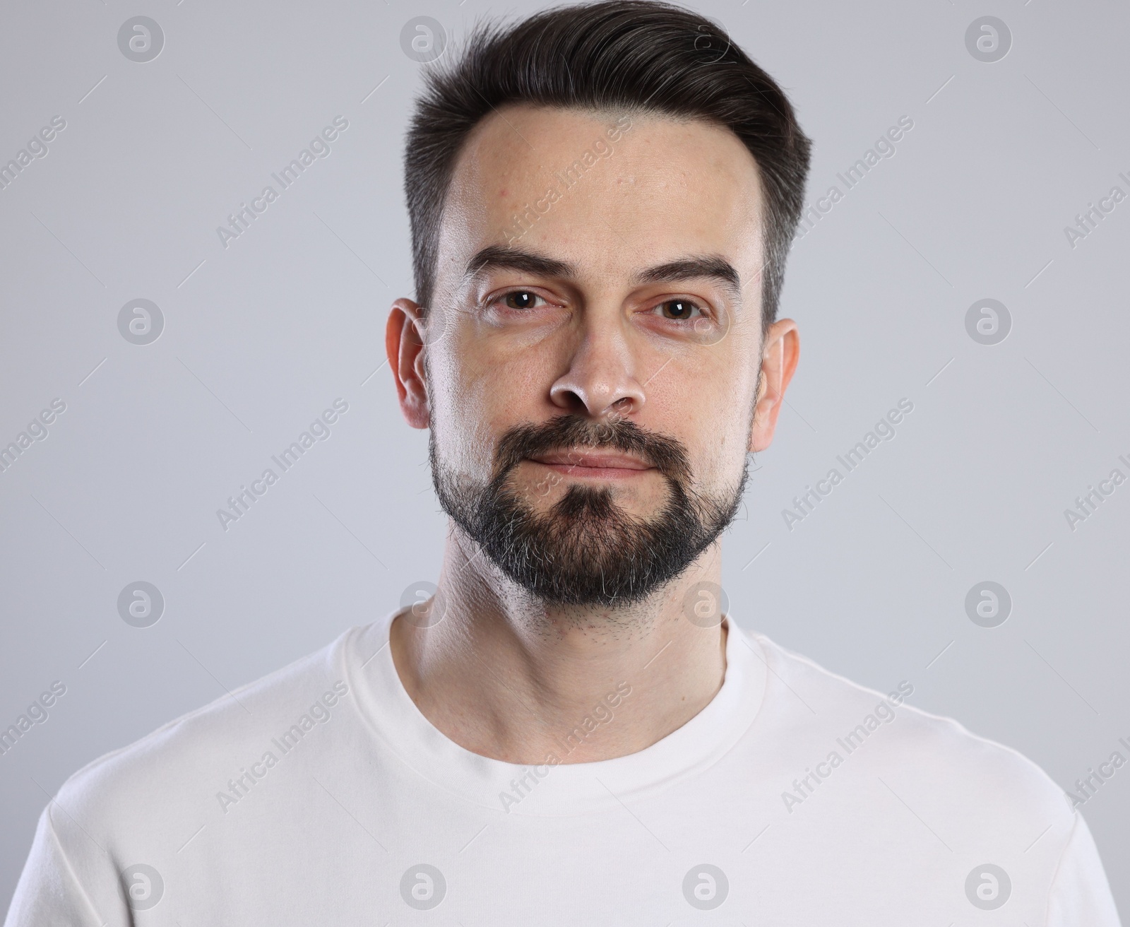 Portrait of handsome man on grey background, closeup Photo of Portrait of handsome man on grey background, closeup
