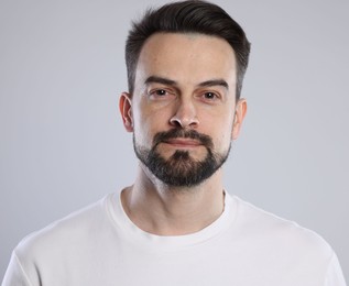 Photo of Portrait of handsome man on grey background, closeup