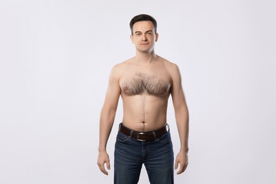 Photo of Man in jeans posing on light grey background