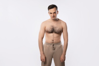 Photo of Man with incorrect posture posing on light grey background