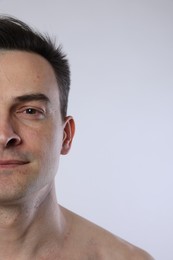 Photo of Handsome man on light grey background, closeup