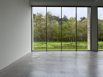 Photo of Empty room with panoramic windows and grey floor