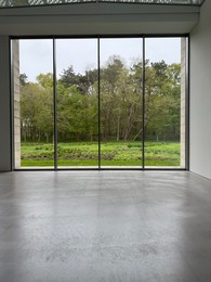 Photo of Empty room with panoramic windows and grey floor
