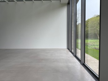 Photo of Empty room with panoramic windows and grey floor