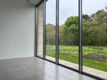 Photo of Empty room with panoramic windows and grey floor