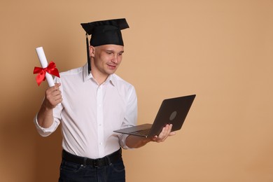 Photo of Happy student with diploma and laptop after graduation on beige background. Space for text