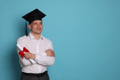 Photo of Happy student with diploma after graduation on light blue background. Space for text